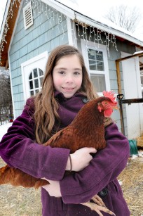 Ten year-old Ella Stier poses with Lila, a favorite Rhode Island Red.